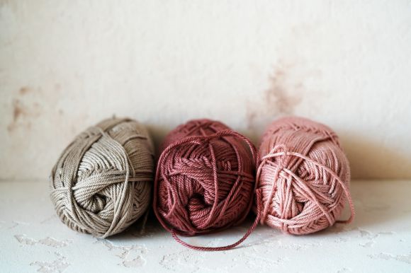 Yarn Amigurumi - three balls of yarn sitting on top of a table