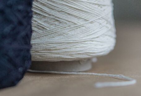 Cotton Yarn - white thread on brown wooden table