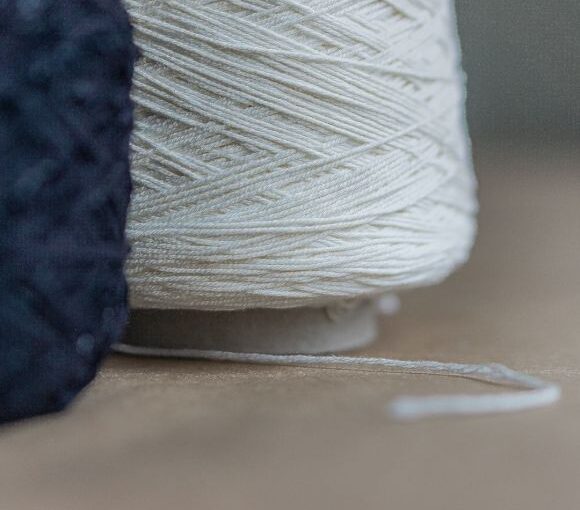 Cotton Yarn - white thread on brown wooden table