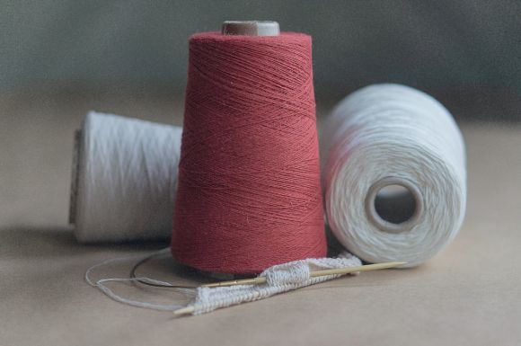 Cotton Yarn - red thread on white paper
