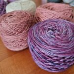 Alpaca Yarn - three balls of yarn sitting on a table