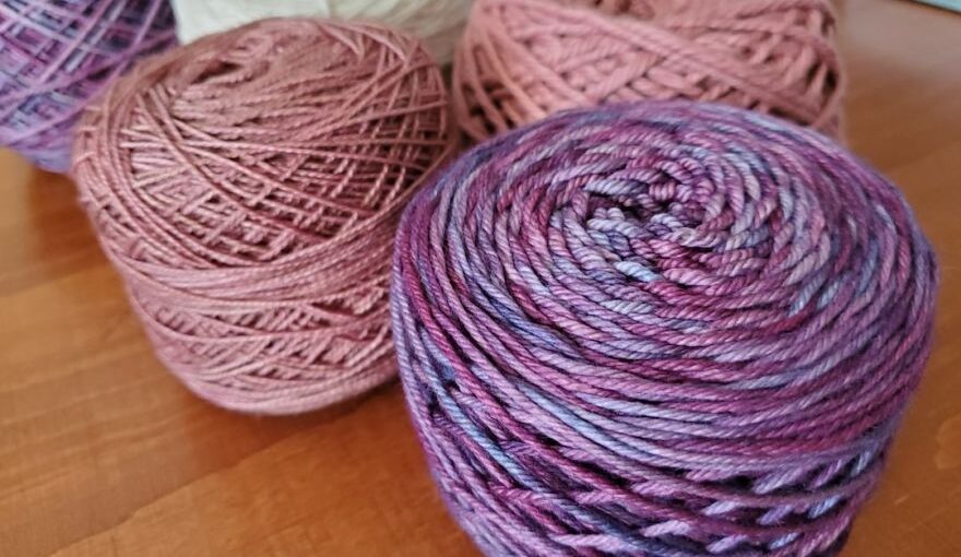 Alpaca Yarn - three balls of yarn sitting on a table