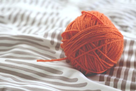 Tencel Yarn - orange yarn ball on white and gray pad