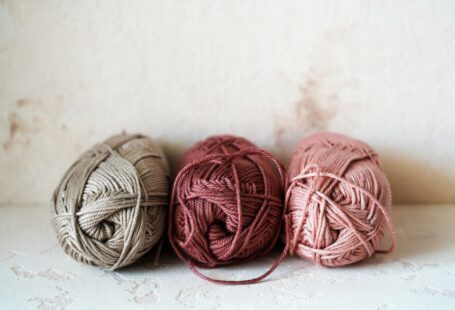 Yarn Tools - three balls of yarn sitting on top of a table