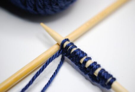 Merino Wool Yarn - black yarn beside brown wooden stick