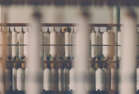 Cotton Yarn - photography of white treadle on brown wooden rack