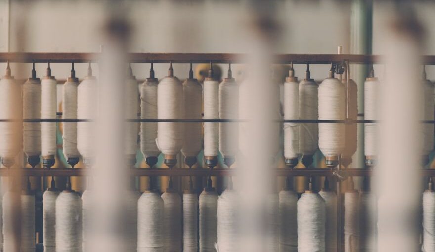 Cotton Yarn - photography of white treadle on brown wooden rack