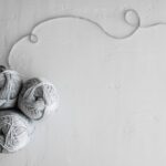 Yarn Tools - flat lay photography of three white yarn balls