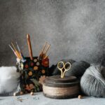 Yarn Tools - a pair of scissors, a ball of yarn, and some knitting needles