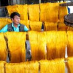 Silk Yarn - A Man Working on a Silk Production
