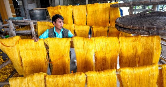 Silk Yarn - A Man Working on a Silk Production