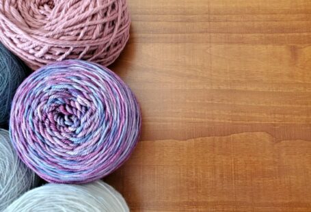 Silk Yarn - a group of balls of yarn sitting on top of a wooden table