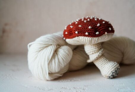 Yarn Tools - a white ball of yarn with a red mushroom on top of it