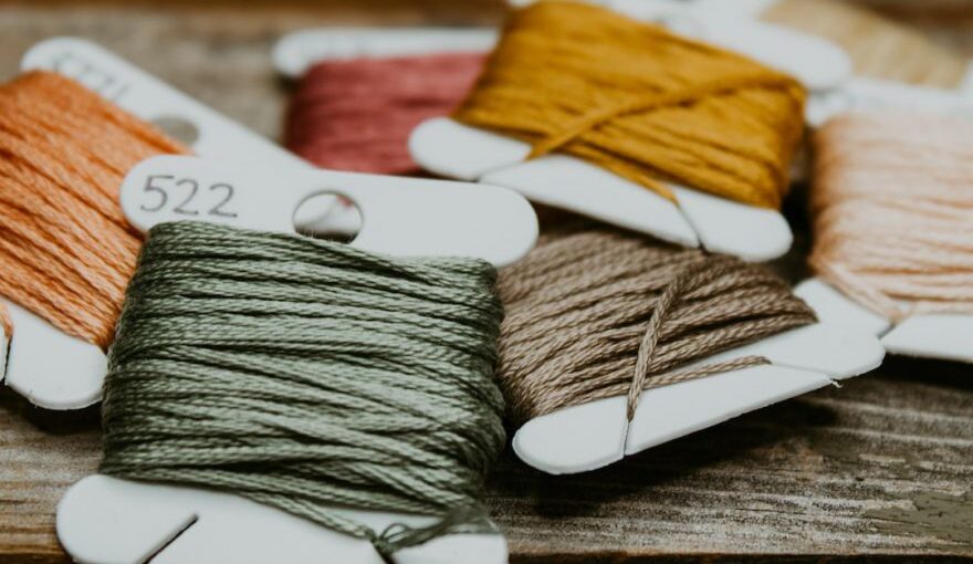 Yarn Tools - green and yellow yarn on brown wooden table