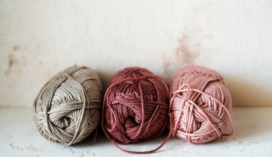 Yarn Tools - three balls of yarn sitting on top of a table