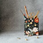 Yarn Tools - a pencil holder with scissors and a pair of scissors in it