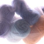 Wool Yarn - three skeins of yarn sitting next to each other